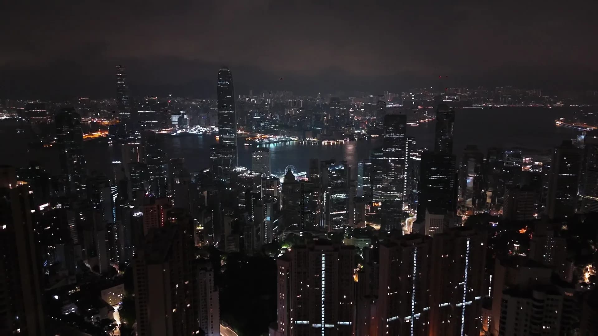 Night aerial view over a dense harbor-front skyline