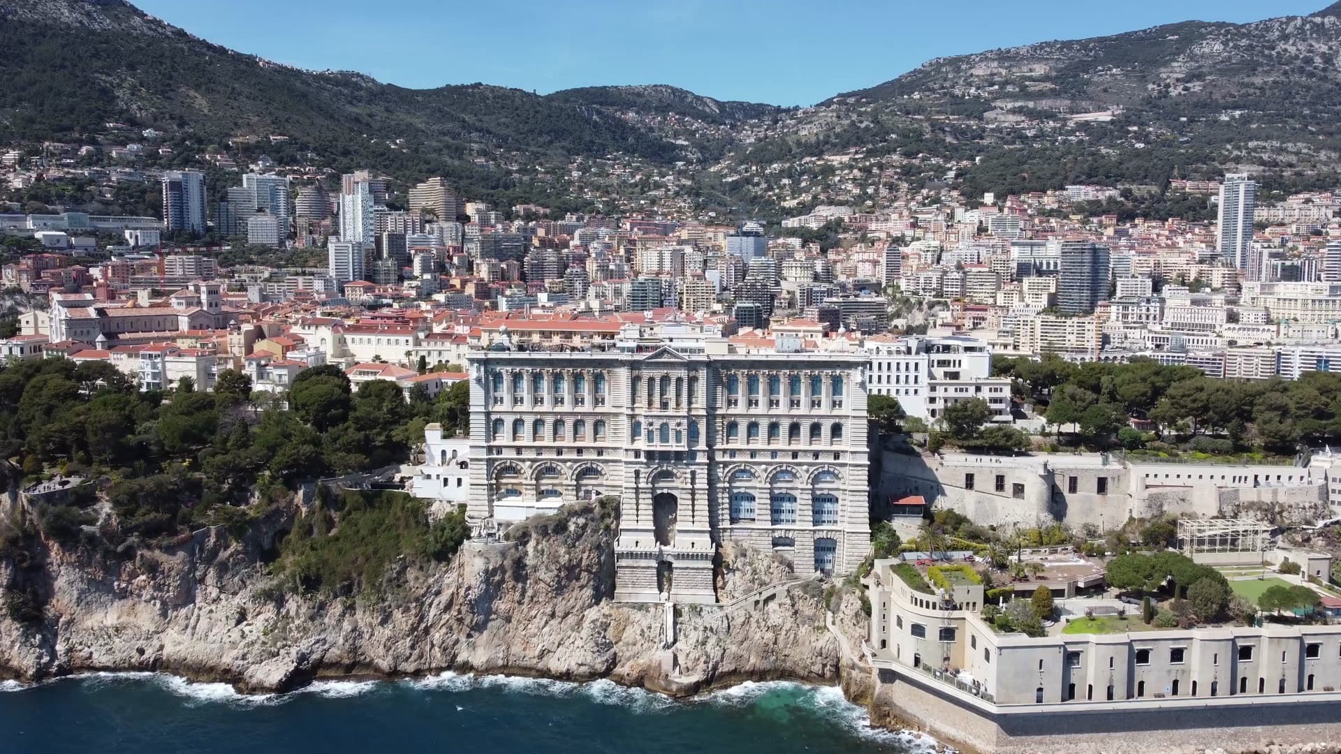 Aerial view of a dense coastal city built along a steep hillside