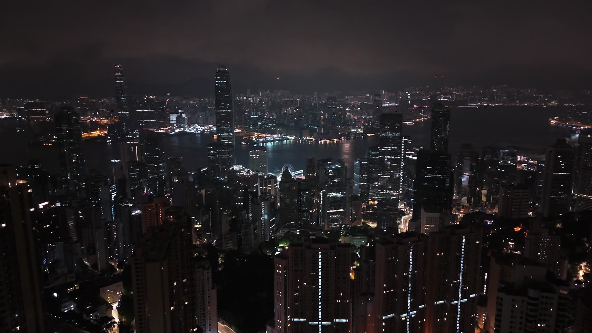 Night aerial view over a dense harbor-front skyline